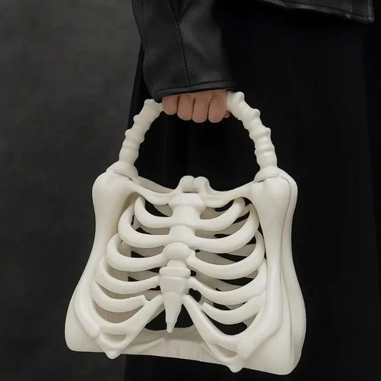 White skeleton handbag held by a person against a dark background