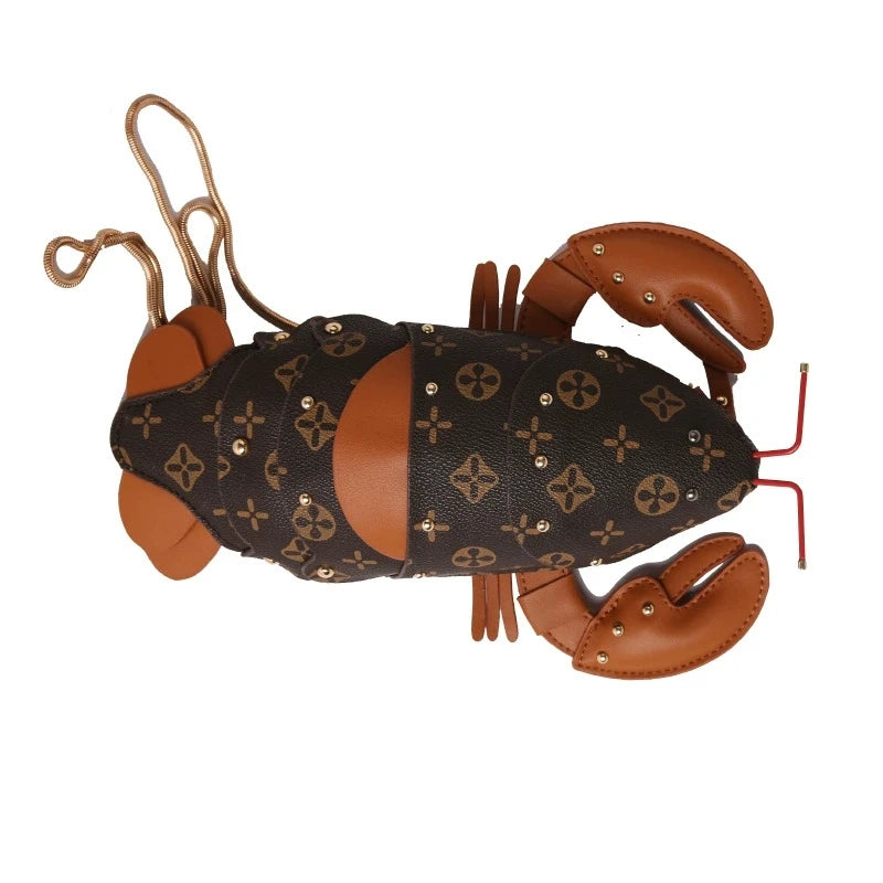 A lobster-shaped handbag featuring Louis Vuitton's classic monogram canvas on the body, brown leather claws and antennae, and small gold-tone studs, shown against a plain white background.