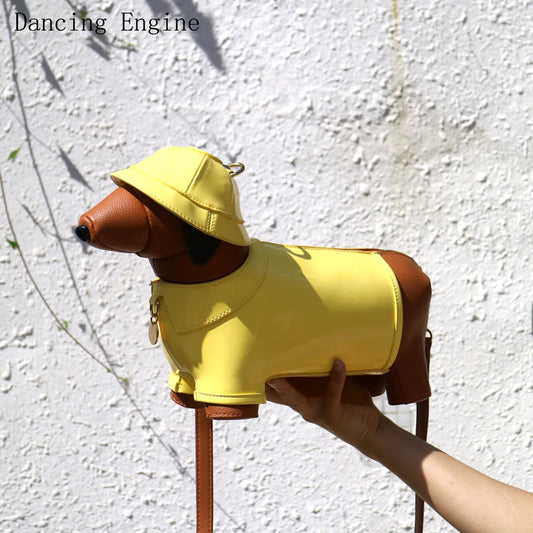 Yellow dog-shaped bag with a brown handle held by a hand against a white wall.
