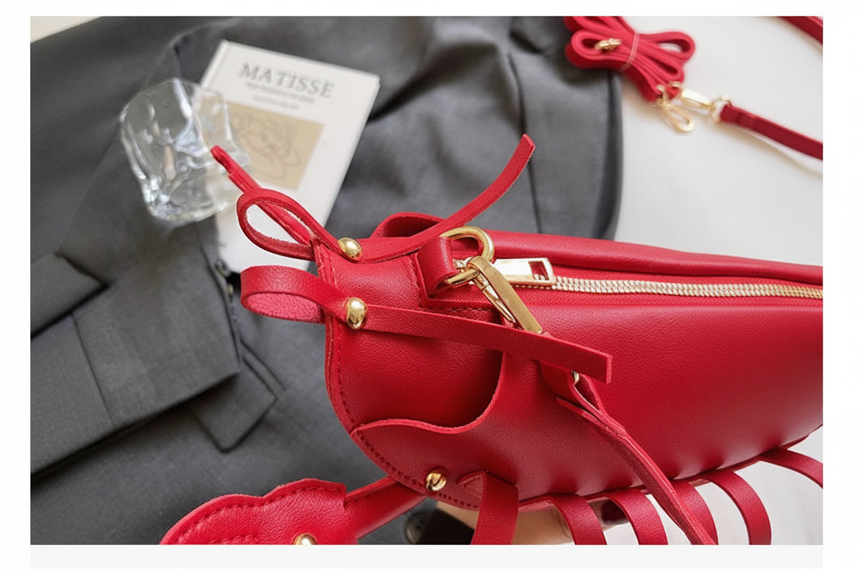 Red handbag with gold accents on a gray background